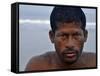 Fisherman Rests While Moving a Traditional Fishing Boat to the Sea at the Colva Beach in Goa, India-null-Framed Stretched Canvas