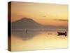 Fisherman Standing in Sea with Mount Agung in the Background, Sanur, Bali, Indonesia-Ian Trower-Stretched Canvas