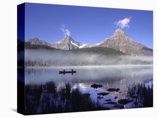 Fishermen in Canoe on Waterfowl Lake, Banff National Park, Canada-Janis Miglavs-Stretched Canvas