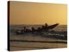 Fishermen Launch their Boat into the Atlantic Ocean at Sunset-Amar Grover-Stretched Canvas