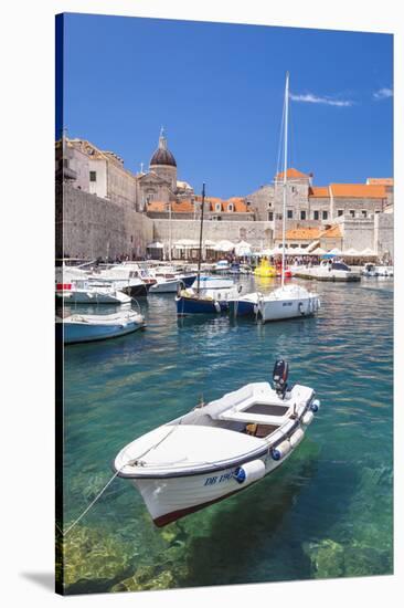 Fishing boat and clear water in the Old Port, Dubrovnik Old Town, Dubrovnik, Dalmatian Coast, Croat-Neale Clark-Stretched Canvas