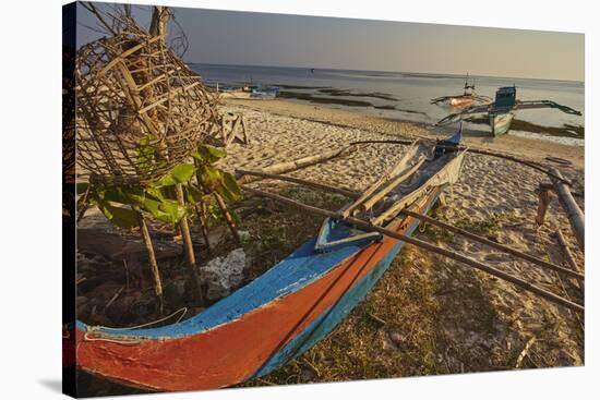 Fishing boats pulled up onto Paliton beach, Siquijor, Philippines, Southeast Asia, Asia-Nigel Hicks-Stretched Canvas
