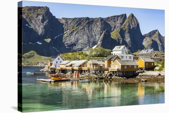 Fishing village on Reinefjorden, Saknesoya, Lofoten Islands-Tony Waltham-Stretched Canvas