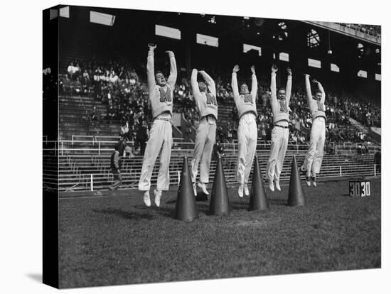 Five Male Maryland Cheerleaders Jumping-null-Stretched Canvas