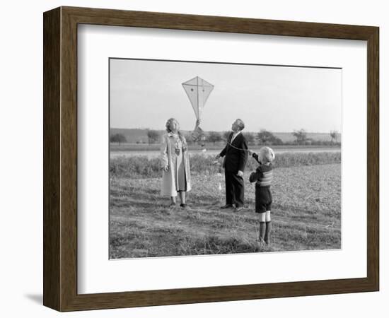 Five Year Old Boy with Mother and Father Fly a Kite, Ca. 1951-null-Framed Photographic Print