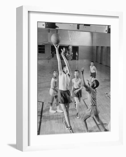 Five Young Boys Wearing Gym Clothes and Playing a Game of Basketball in the School Gym-null-Framed Photographic Print