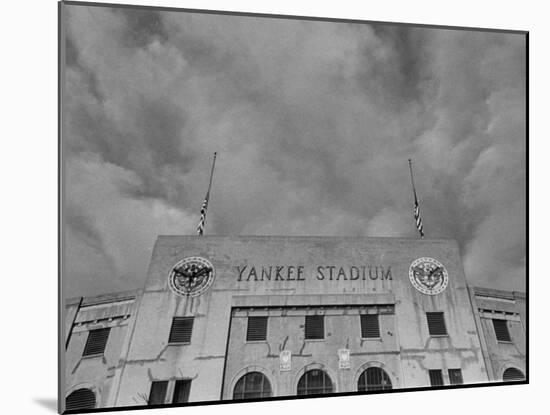 Flags Flying at Half Mast on Top of Yankee Stadium to Honor Late Baseball Player Babe Ruth-Cornell Capa-Mounted Photographic Print