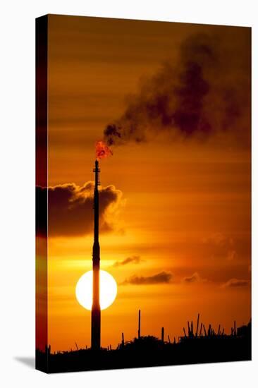 Flames and Smoke Billow from Natural Gas Flare at Valero Oil Refinery at Sunset-null-Stretched Canvas