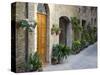 Flower Pots and Potted Plants Decorate a Narrow Street in Tuscan Village, Pienza, Italy-Dennis Flaherty-Stretched Canvas