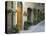 Flower Pots and Potted Plants Decorate a Narrow Street in Tuscan Village, Pienza, Italy-Dennis Flaherty-Stretched Canvas