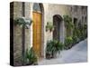 Flower Pots and Potted Plants Decorate a Narrow Street in Tuscan Village, Pienza, Italy-Dennis Flaherty-Stretched Canvas