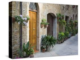 Flower Pots and Potted Plants Decorate a Narrow Street in Tuscan Village, Pienza, Italy-Dennis Flaherty-Stretched Canvas