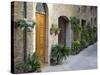 Flower Pots and Potted Plants Decorate a Narrow Street in Tuscan Village, Pienza, Italy-Dennis Flaherty-Stretched Canvas