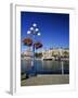 Flower Pots Hanging on Street Light-James Randklev-Framed Photographic Print