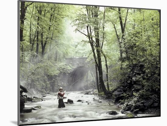 Fly Fisherman Near a Stone Bridge-null-Mounted Photographic Print