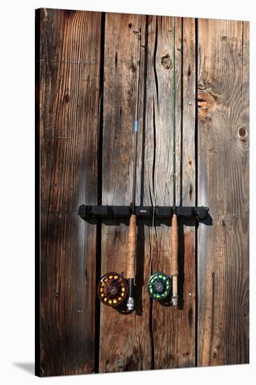 Fly Fishing Rods On The Side Of An Angler's Warming Hut-Ben Herndon-Stretched Canvas