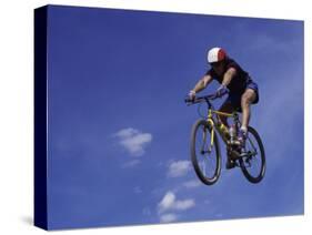 Flying Cyclist-null-Stretched Canvas