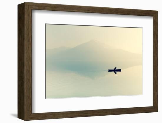 Fog over the Lake. Silhouette of Mountains in the Background. the Man Floats in a Boat with a Paddl-Maryna Patzen-Framed Photographic Print