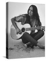 Folk Singer Joan Baez Strumming Her Guitar on the Beach Near Her Home-Ralph Crane-Stretched Canvas