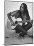 Folk Singer Joan Baez Strumming Her Guitar on the Beach Near Her Home-Ralph Crane-Mounted Premium Photographic Print