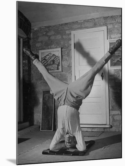 Folk Singer John Jacob Niles Performing Elbow-Standing Exercise, Adapted from Yoga, to Relax-null-Mounted Photographic Print