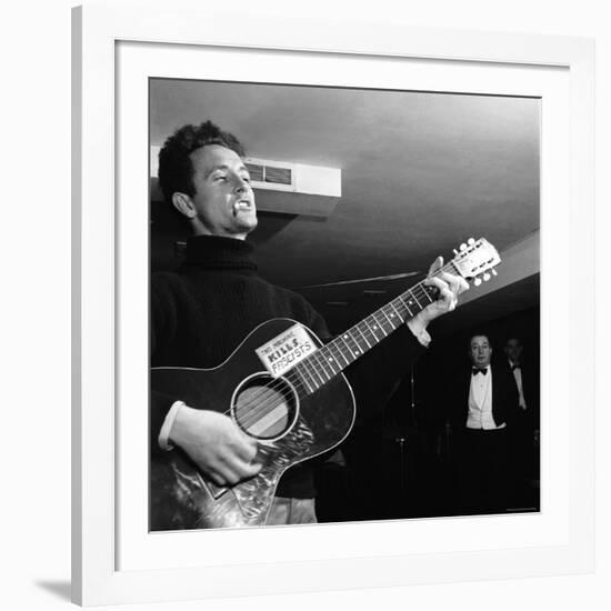 Folk Singer Woody Guthie Performing with Guitar Emblazoned with "This Machine Kills Fascists"-Eric Schaal-Framed Premium Photographic Print