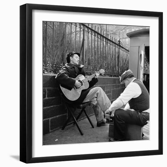 Folk Singer Woody Guthrie Palying His Guitar While Getting a Shoeshine-null-Framed Premium Photographic Print