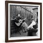 Folk Singer Woody Guthrie Palying His Guitar While Getting a Shoeshine-null-Framed Premium Photographic Print