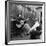 Folk Singer Woody Guthrie Palying His Guitar While Getting a Shoeshine-null-Framed Premium Photographic Print