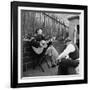 Folk Singer Woody Guthrie Palying His Guitar While Getting a Shoeshine-null-Framed Premium Photographic Print