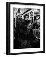 Folk Singer Woody Guthrie Singing Aboard a Subway Train-null-Framed Premium Photographic Print