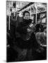 Folk Singer Woody Guthrie Singing Aboard a Subway Train-null-Mounted Premium Photographic Print