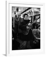 Folk Singer Woody Guthrie Singing Aboard a Subway Train-null-Framed Premium Photographic Print