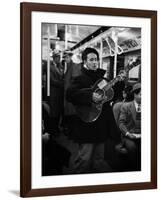 Folk Singer Woody Guthrie Singing Aboard a Subway Train-null-Framed Premium Photographic Print