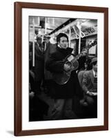 Folk Singer Woody Guthrie Singing Aboard a Subway Train-null-Framed Premium Photographic Print