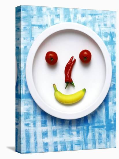 Food Collage: Face Made from Banana, Chili & Tomatoes on Plate-Dorota & Bogdan Bialy-Stretched Canvas