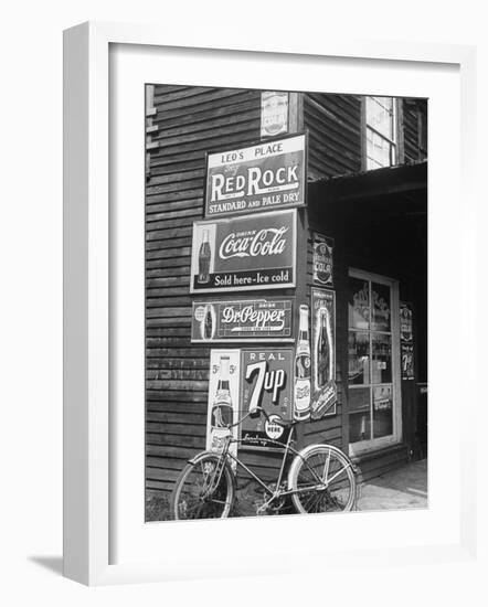 Food Store Called Leo's Place Covered with Beverage Ads Incl. Coca Cola, 7 Up, Dr. Pepper and Pepsi-Alfred Eisenstaedt-Framed Photographic Print