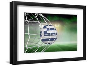 Football in Greece Colours at Back of Net against Football Pitch under Green Sky and Spotlights-Wavebreak Media Ltd-Framed Photographic Print