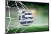Football in Greece Colours at Back of Net against Football Pitch under Green Sky and Spotlights-Wavebreak Media Ltd-Mounted Photographic Print