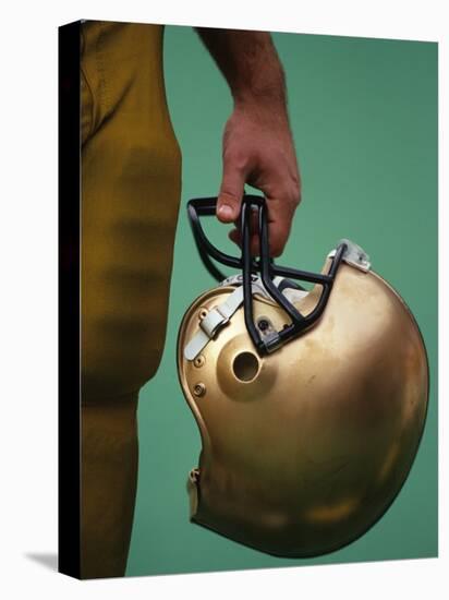 Football Player Holding His Helmet-Chris Trotman-Stretched Canvas