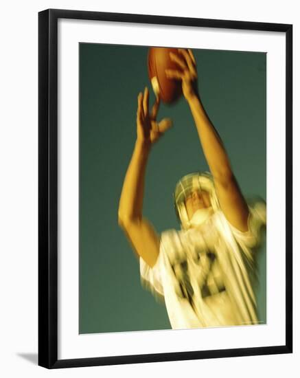Football Player Reaching Up To Catch a Ball-null-Framed Photographic Print
