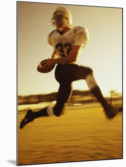 Football Player Running with The Ball-null-Mounted Premium Photographic Print