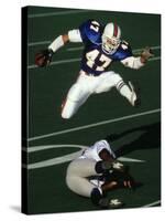 Football Running Back Flys over the Defense-null-Stretched Canvas