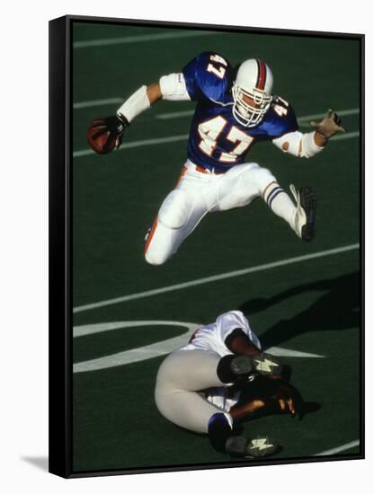 Football Running Back Flys over the Defense-null-Framed Stretched Canvas