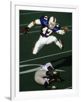 Football Running Back Flys over the Defense-null-Framed Photographic Print