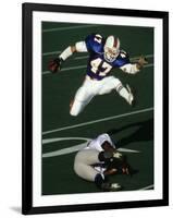 Football Running Back Flys over the Defense-null-Framed Photographic Print