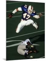 Football Running Back Flys over the Defense-null-Mounted Photographic Print