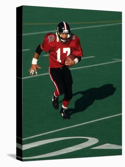 Football Running Back in Action-null-Stretched Canvas