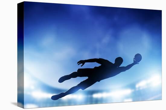 Football, Soccer Match. A Goalkeeper Jumping to Defend, save the Ball from Goal. Lights on the Stad-Michal Bednarek-Stretched Canvas
