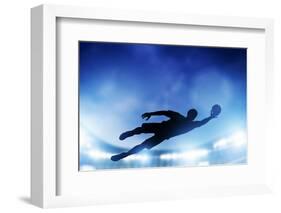 Football, Soccer Match. A Goalkeeper Jumping to Defend, save the Ball from Goal. Lights on the Stad-Michal Bednarek-Framed Photographic Print